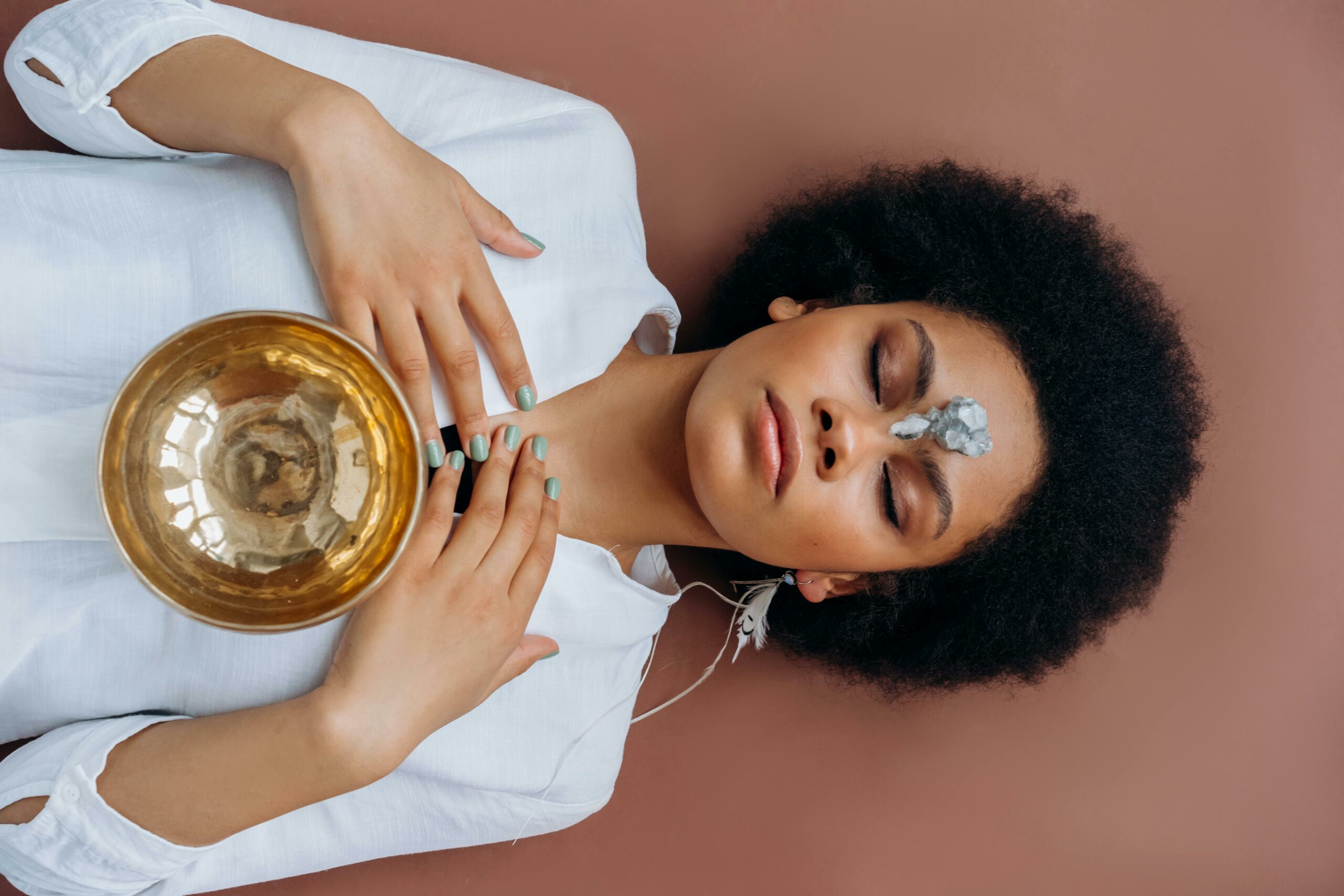 Energy Work Tibetan singing bowl on a woman s chest lying on the ground