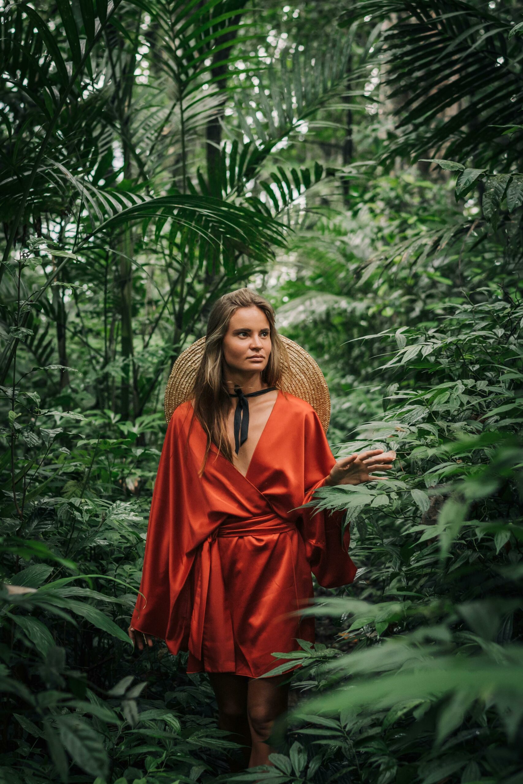 woman-in-red-dress-walking-between-green-plants-stockpack-pexels Woman in red dress walking between green plants